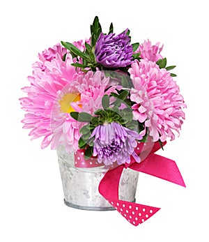 Pink and purple aster flowers in a small metal bucket