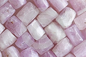 Pink purple background of natural stones. Kunzite is a natural p