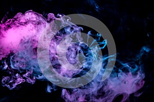 Of pink purple and blue wavy smoke on a black isolated background. Abstract pattern of steam from vape of rising clouds