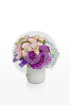 Pink and purple flower arrangement. Roses and hydrangea in a white vase designed for florist.