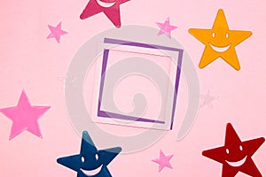 pink-purple frame as copy space on a pink background, colorful stars around the frame, creative art minimal concept