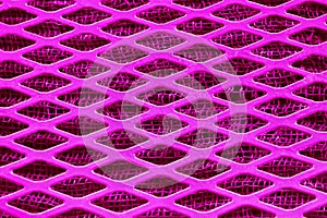 Pink Purple metal lattice lozenge rhombus close-up, under a fine metal grid.