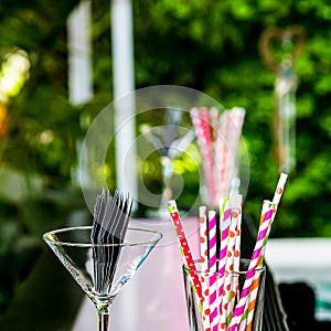 Pink and purple straws in a glass