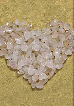 Pink quart crystals heart shape  closeup on elegant white photo