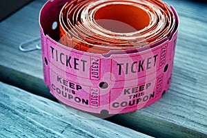 pink raffle tickets on wood