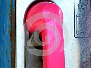 Pink receiver of old coin operated street phone