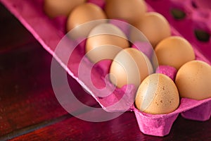 Pink box of eggs in close-up