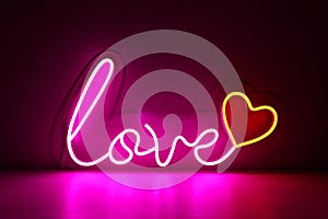 Pink and red neon heart with the inscription love. Valentine day