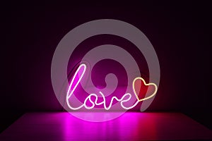 Pink and red neon heart with the inscription love. Valentine day