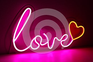 Pink and red neon heart with the inscription love. Valentine day