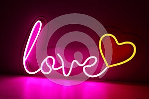 Pink and red neon heart with the inscription love. Valentine day