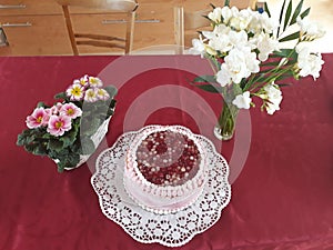 Pink red and white currant cake with flower decoration