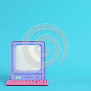 Pink retro computer on bright blue background in pastel colors