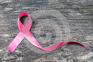 Pink ribbon breast cancer awareness symbolic bow color raising support on people living with women`s breast tumor illness