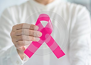 Pink ribbon for breast cancer awareness and women`s health care campaign concept on female tumor illness in October month