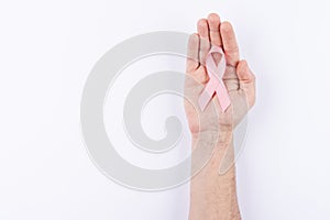 Pink ribbon over palm. White background