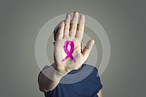 A pink ribbon painted in the palm