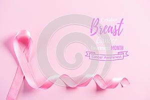 Pink ribbon on pink pastel paper background for supporting breast cancer awareness month campaign