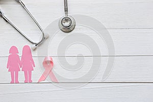 Pink ribbon and stethoscope on white wooder background, Symbol of breast cancer in women, Health care concept