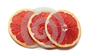 Pink ripe grapefruit slice on white isolated background. Half and slice of grapefruit isolated on white.