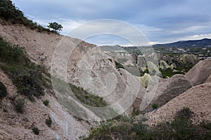 Pink rocks of unusual shapes in a valley in Cappadocia. Magnificent landscape