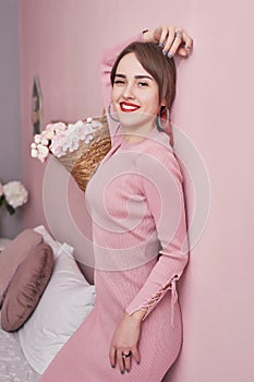 Pink room interior. Woman in bedroom. Close up lifestyle portrait of pensive woman. Cozy morning. Luxury bachelorette party in