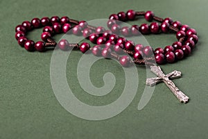 Pink Rosary on a green background.