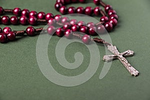 Pink Rosary on a green background.