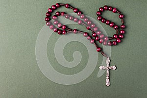 Pink Rosary on a green background.