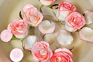 Pink rose, candles and petal floating water in bowl. Relaxing Hand Spa