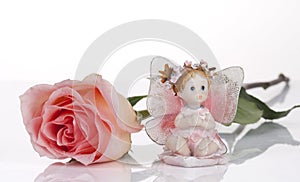 Pink rose and and ceramic angel