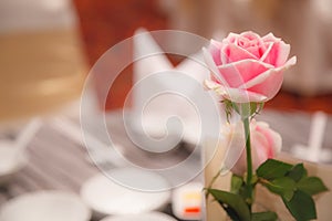 Pink rose decoration on banquet table settings. Hotel restaurant venue, food catering service buffet or cocktail banquet for