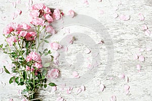 Pink rose flowers bouquet mockup on white rustic wooden background