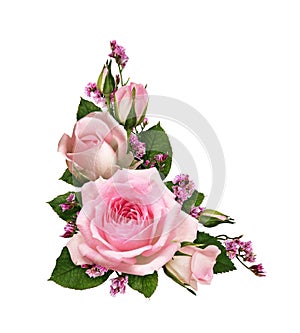 Pink rose flowers and limonium in a corner floral arrangement isolated on white