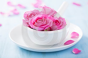 Pink rose flowers in mortar for aromatherapy and spa