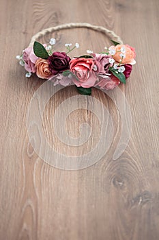 Pink rose flowers wraith on wooden background