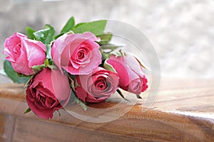 pink rose in the pile of roses flowers on wood ground