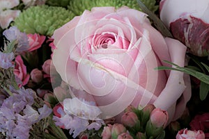 Pink rose in a vintage color spring flower bouquet with chrysanthemums, kalanchoes,peony, on blurred background