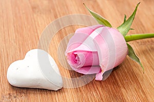 Pink rose with white chocolate cake on the wooden board