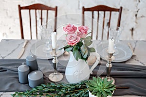 Decoration of the table. Bouquet of pink roses in a vase