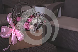 Pink roses in a basket on the table