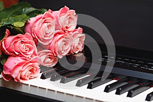 Pink roses bouquet on digital piano keys