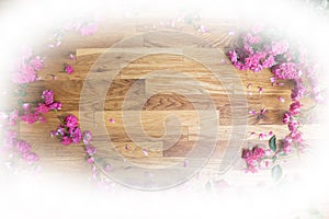 Pink roses on brawn wooden background, view from above
