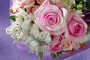 Pink roses in center of pretty bouquet of flowers