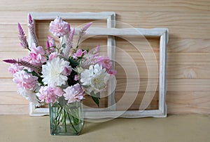 Pink roses,cockscomb,white flower in a vase and vintage frame