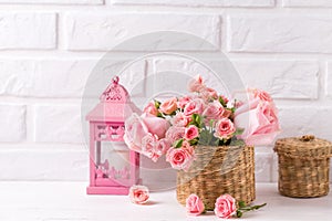 Pink roses flowers and decorative pinke lantern against white b