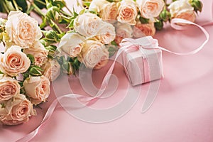 Pink roses flowers and gift or present box pink background. Mothers Day, Birthday, Valentines Day, Womens Day concept