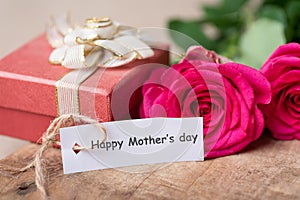 Pink roses and gift box with Happy Mother`s day tag card