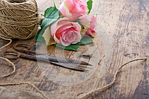 Pink roses with old rusty antique scissors