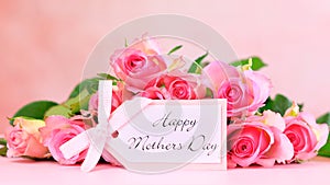 Pink roses on pink wood table, Mother`s Day background closeup. photo